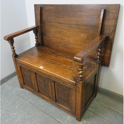 713 - A good quality medium oak monk’s bench in the 17th century taste, having a sliding backrest joined w... 