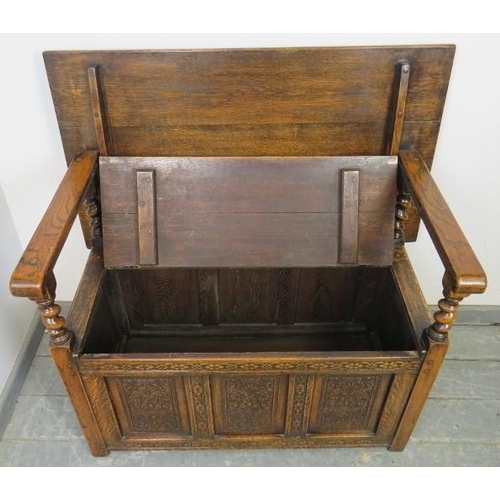 713 - A good quality medium oak monk’s bench in the 17th century taste, having a sliding backrest joined w... 