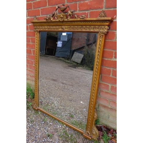 714 - A 19th century over-mantle mirror, the cornice with Classical urn flanked by swags, within an ornate... 