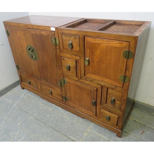 717 - A vintage Chinese elm stepped room-divider, housing an array of six double-sided drawers and three c... 