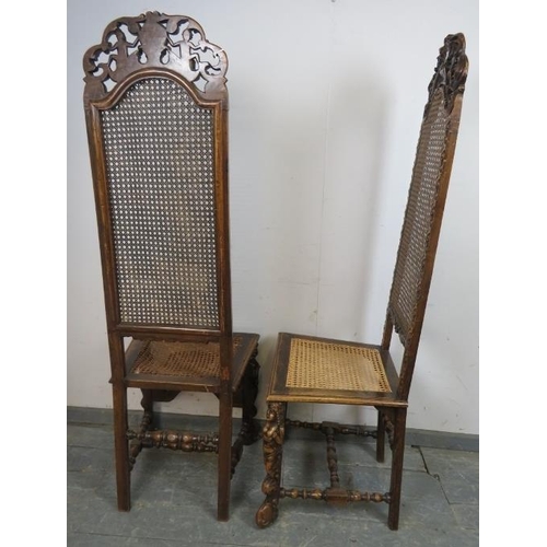 722 - A pair of 19th century fruitwood high back bergère hall chairs in the Carolean taste, the carved and... 