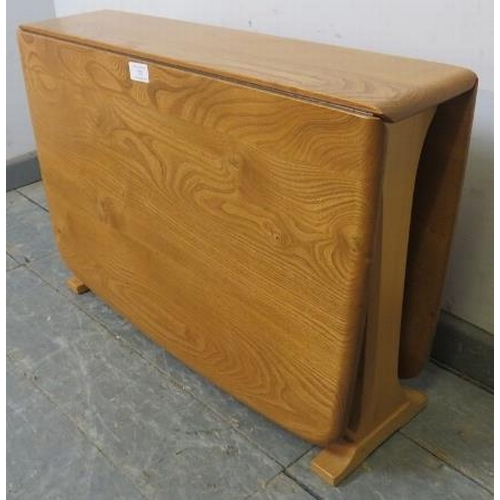 725 - A vintage blonde elm and beech drop-leaf Sutherland/coffee table by Ercol (model 820) on splayed sup... 