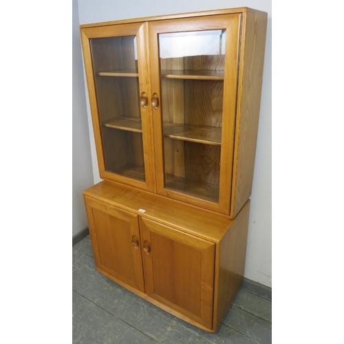 728 - A mid-century blonde elm Windsor display cabinet/sideboard by Ercol (model 805) the bevelled glass d... 