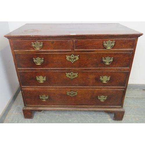 730 - An 18th century oak chest of two short over three long graduated, cock-beaded drawers with pierced b... 