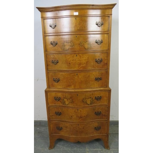 731 - A reproduction serpentine fronted burr walnut chest on chest in the Georgian taste, having seven gra... 