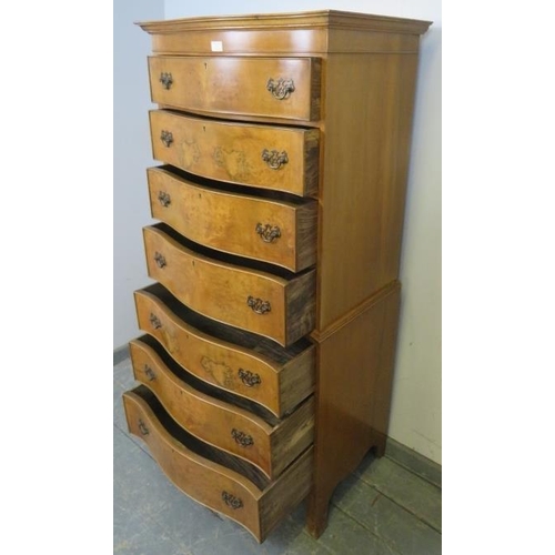 731 - A reproduction serpentine fronted burr walnut chest on chest in the Georgian taste, having seven gra... 