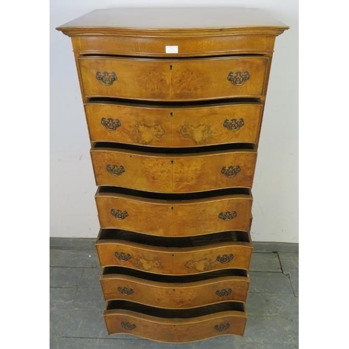 731 - A reproduction serpentine fronted burr walnut chest on chest in the Georgian taste, having seven gra... 