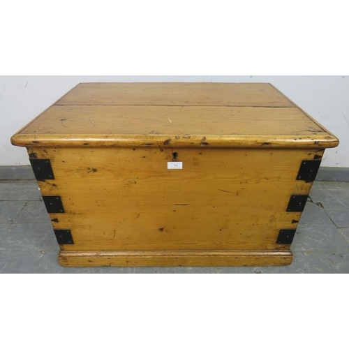 736 - An antique pine flat topped trunk/blanket box, metal bound and having handles to with side, on a pli... 