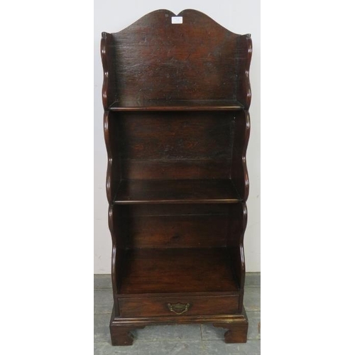 738 - A George III mahogany ‘waterfall’ narrow bookcase of three graduated open shelves, above one long dr... 