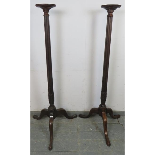 739 - A tall pair of 19th century and later mahogany jardinières/plant stands, the dished tops above taper... 