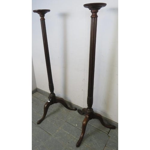 739 - A tall pair of 19th century and later mahogany jardinières/plant stands, the dished tops above taper... 