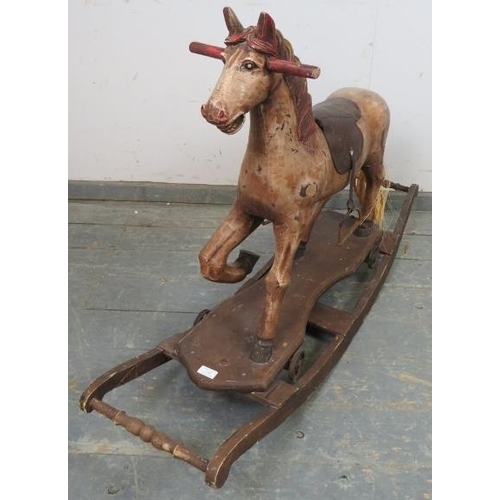 740 - A hand carved vintage rocking horse, with leather saddle and real horsehair tail, on a rocking base.... 