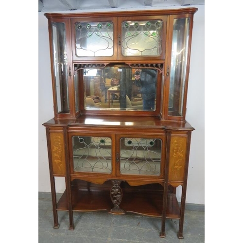 741 - An Art Nouveau mahogany mirror-backed display cabinet, the doors with leaded lights and green glass ... 