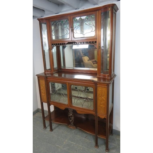 741 - An Art Nouveau mahogany mirror-backed display cabinet, the doors with leaded lights and green glass ... 