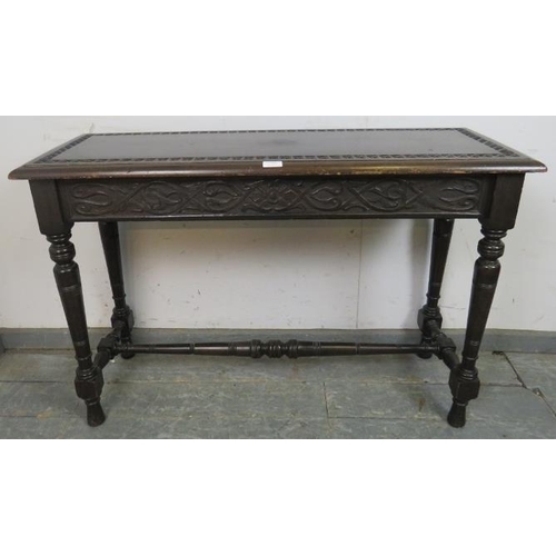 743 - A 19th century mahogany narrow hall table in the Gothic taste, having relief carved top above an aca... 