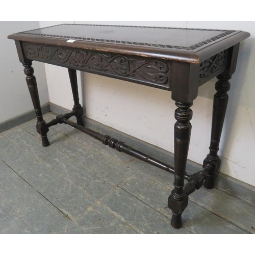 743 - A 19th century mahogany narrow hall table in the Gothic taste, having relief carved top above an aca... 