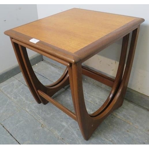 749 - Two mid-century teak ‘astro’ nesting tables by G-Plan, the crossbanded tops on curved supports with ... 