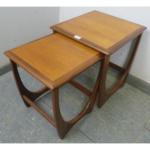 749 - Two mid-century teak ‘astro’ nesting tables by G-Plan, the crossbanded tops on curved supports with ... 