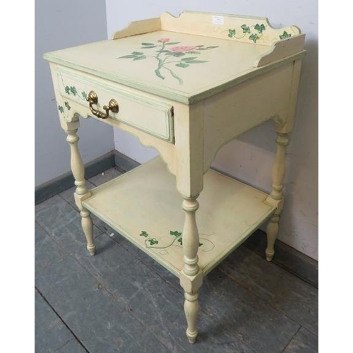 752 - A solid oak two tier side table by Whitney furniture, hand-painted with floral motifs, the ¾ gallery... 