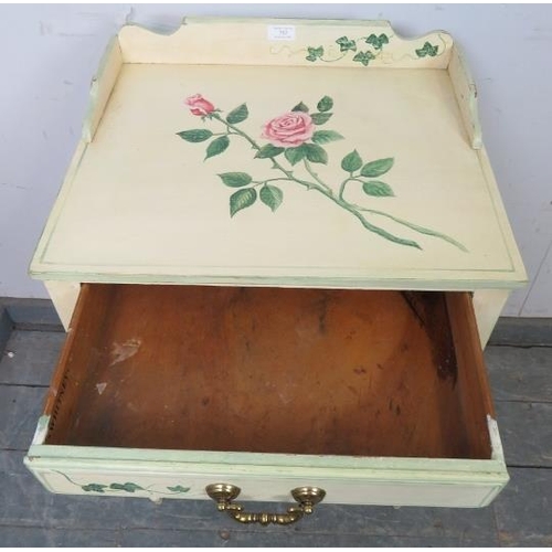 752 - A solid oak two tier side table by Whitney furniture, hand-painted with floral motifs, the ¾ gallery... 