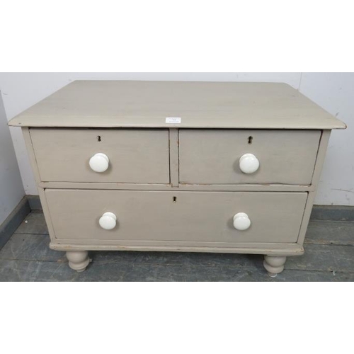 755 - A small antique pine chest painted grey, housing two short over one long drawer with ceramic knob ha... 