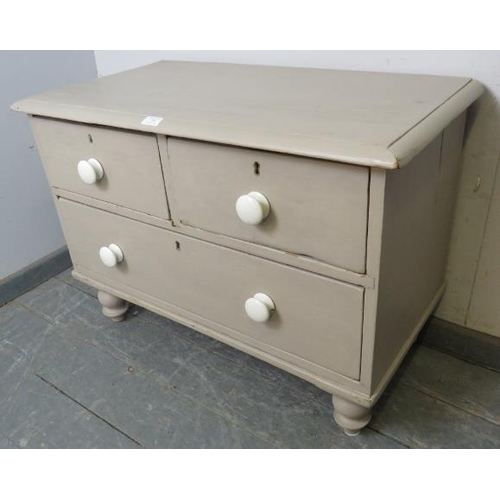 755 - A small antique pine chest painted grey, housing two short over one long drawer with ceramic knob ha... 