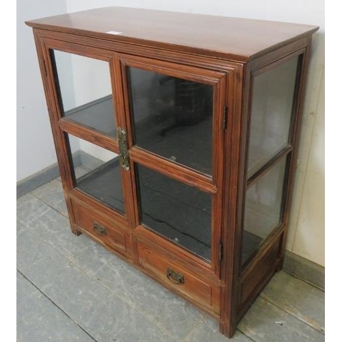 762 - A vintage Chinese elm glazed display cabinet, having one loose shelf, above two short drawers with c... 