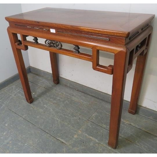 763 - A vintage Chinese elm altar table in the 18th century style, having carved and pierced fretwork frie... 