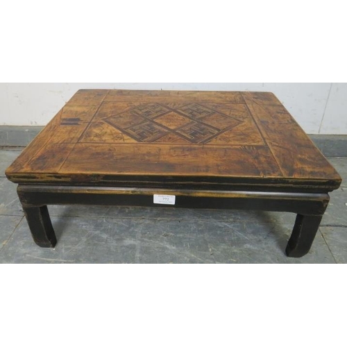 772 - An early 20th century Chinese elm low table, having a parquetry inlaid and hand decorated top, on fo... 