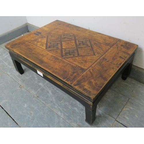 772 - An early 20th century Chinese elm low table, having a parquetry inlaid and hand decorated top, on fo... 