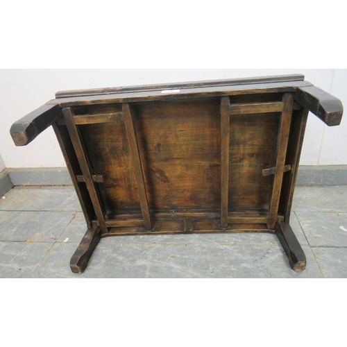 772 - An early 20th century Chinese elm low table, having a parquetry inlaid and hand decorated top, on fo... 