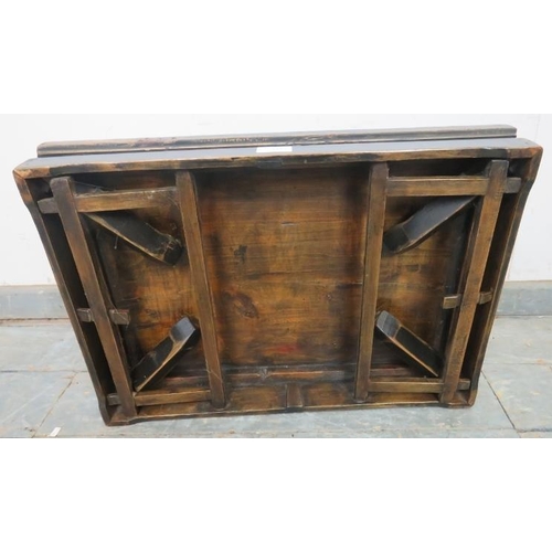 772 - An early 20th century Chinese elm low table, having a parquetry inlaid and hand decorated top, on fo... 