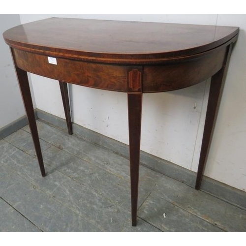 773 - A Georgian mahogany turnover tea table, crossbanded and strung with boxwood, satinwood and ebony, on... 