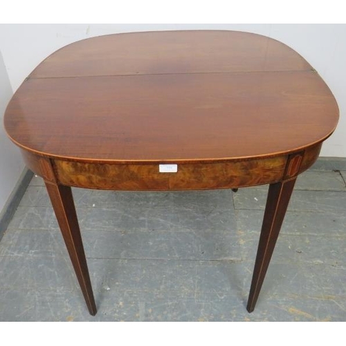 773 - A Georgian mahogany turnover tea table, crossbanded and strung with boxwood, satinwood and ebony, on... 