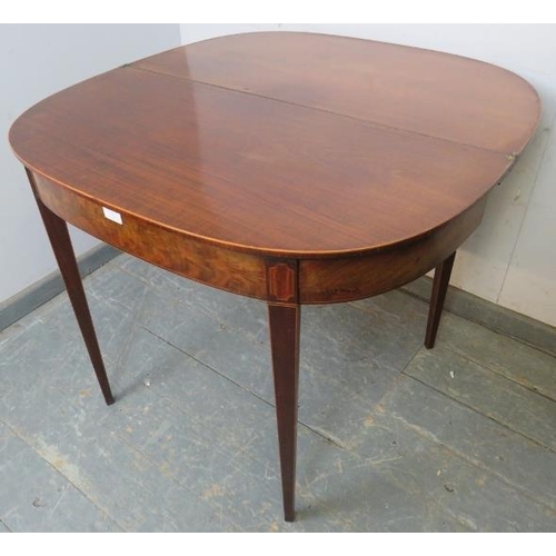 773 - A Georgian mahogany turnover tea table, crossbanded and strung with boxwood, satinwood and ebony, on... 