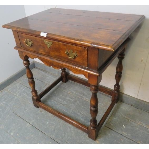 778 - A good quality solid oak side table in the 18th century taste, having one long drawer with brass bat... 