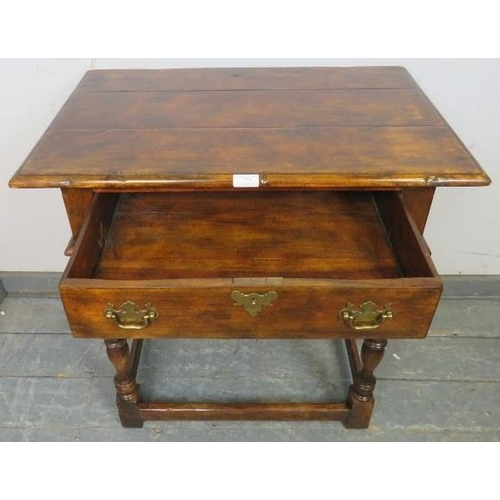 778 - A good quality solid oak side table in the 18th century taste, having one long drawer with brass bat... 