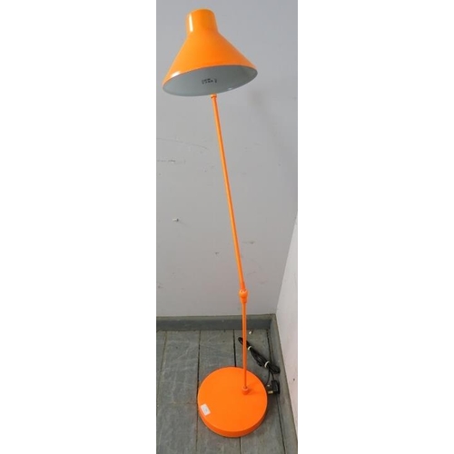 786 - A contemporary floor-standing angle poise lamp in tangerine, on a circular plinth base. 
H124cm Diam... 