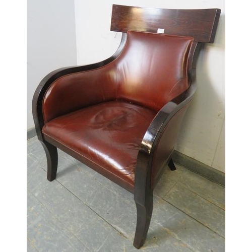 787 - A contemporary fruitwood armchair in the French Empire style, upholstered in supple tobacco brown le... 