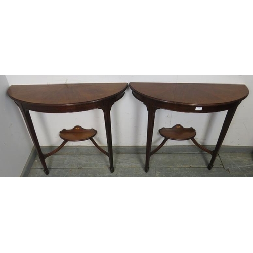 789 - A pair of Edwardian mahogany demi-lune console tables, strung with ebony, on tapered square supports... 