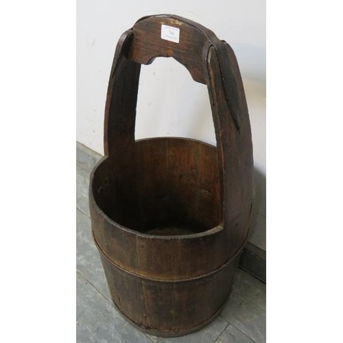 790 - An antique fruitwood coopered well bucket/pail with cast iron handle mounts.  
H66cm W33cm D32cm (ap... 