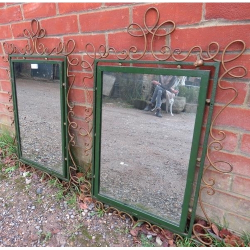 795 - A pair of vintage wrought iron wall mirrors, in ornately scrolled surrounds painted gold and green. ... 