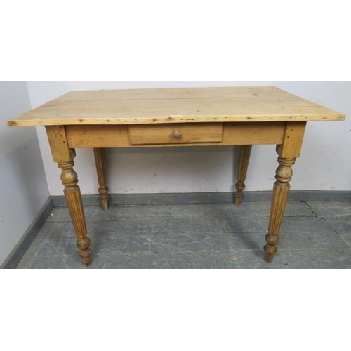 800 - An antique stripped pine kitchen table with single central drawer, on tapered fluted supports. 
H73c... 