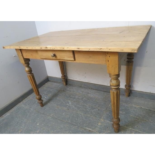 800 - An antique stripped pine kitchen table with single central drawer, on tapered fluted supports. 
H73c... 