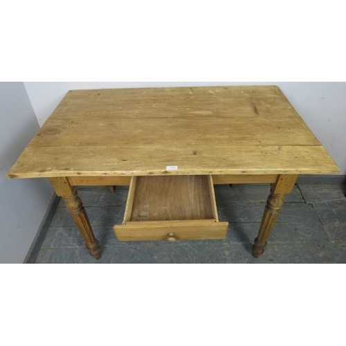 800 - An antique stripped pine kitchen table with single central drawer, on tapered fluted supports. 
H73c... 