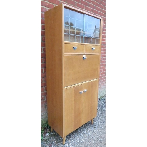 806 - A mid-century light oak kitchenette/drinks cabinet, having sliding glass doors opening onto a displa... 