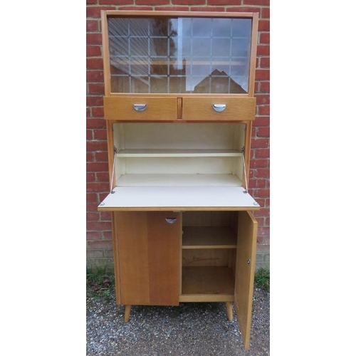 806 - A mid-century light oak kitchenette/drinks cabinet, having sliding glass doors opening onto a displa... 