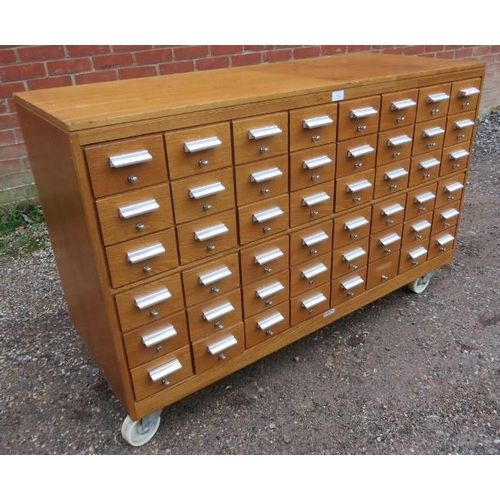 808 - A vintage light oak bank of 48 library index drawers by Serota, with aluminium pull handles and stee... 