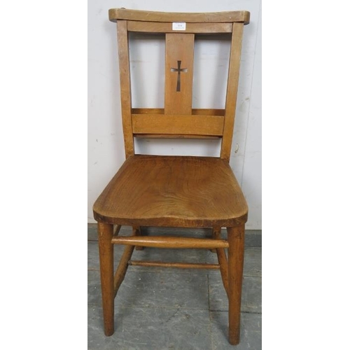 814 - A turn of the century elm and beech ecclesiastical prayer chair, having pierced crucifix decoration,... 