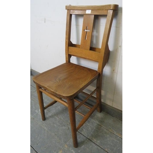 814 - A turn of the century elm and beech ecclesiastical prayer chair, having pierced crucifix decoration,... 